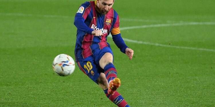 Barcelona's Argentinian forward Lionel Messi kicks the ball during the Spanish League football match between Barcelona and SD Huesca at the Camp Nou stadium in Barcelona on March 15, 2021. (Photo by LLUIS GENE / AFP)