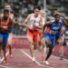 Netherlands' Ramsey Angela (L), Poland's Kajetan Duszynski (C) and Dominican Republic's Alexander Ogando Bautista compete in  the mixed 4x400m relay final during the Tokyo 2020 Olympic Games at the Olympic Stadium in Tokyo on July 31, 2021. (Photo by Jewel SAMAD /