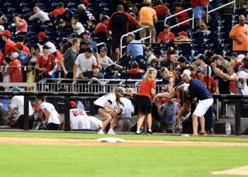 WASHINGTON, DC - JULY 17: Fans run for cover after what was believed to be shots were heard during a baseball game between the San Diego Padres the Washington Nationals at Nationals Park on July 17, 2021 in Washington, DC.   Mitchell Layton/Getty Images/AFP (Photo by Mitchell Layton / GETTY IMAGES NORTH AMERICA / Getty Images via AFP)