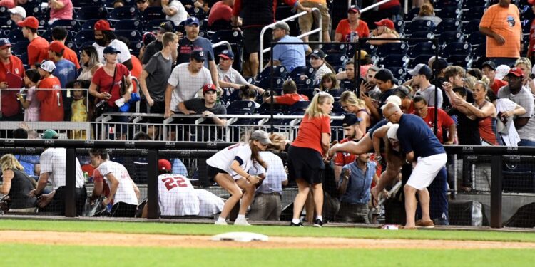 WASHINGTON, DC - JULY 17: Fans run for cover after what was believed to be shots were heard during a baseball game between the San Diego Padres the Washington Nationals at Nationals Park on July 17, 2021 in Washington, DC.   Mitchell Layton/Getty Images/AFP (Photo by Mitchell Layton / GETTY IMAGES NORTH AMERICA / Getty Images via AFP)