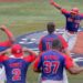 Dominican Republic's Erick Mejia (top R) celebrate his scoring with teammates during the eighth inning of the Tokyo 2020 Olympic Games baseball bronze medal game between Dominican Republic and South Korea at Yokohama Baseball Stadium in Yokohama, Japan, on August 7, 2021. (Photo by KAZUHIRO FUJIHARA / AFP)