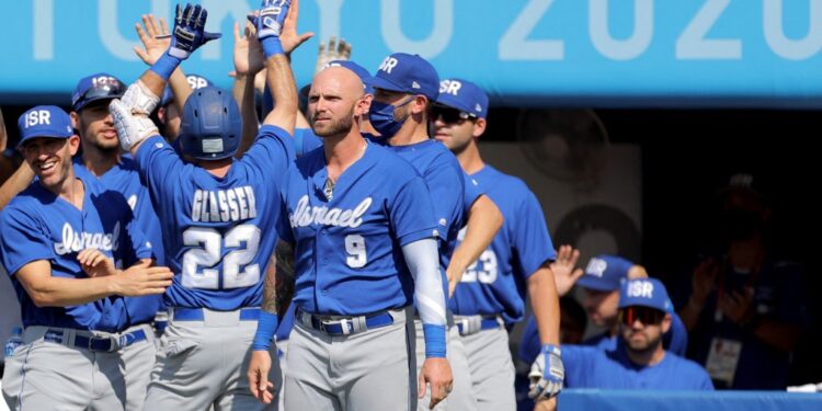Israel's Mitchell Glasser (3rd L, #22) is congratulated by teammates on his scoring during the seventh inning of the Tokyo 2020 Olympic Games baseball round 1 game between Israel and Mexico at Yokohama Baseball Stadium in Yokohama, Japan, on August 1, 2021. (Photo by KAZUHIRO FUJIHARA / AFP)